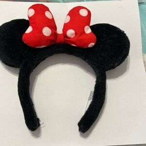 Disney traditional Minnie Mouse ears with red polka dot bow.